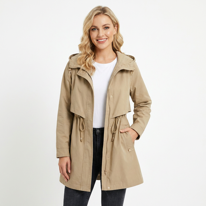 Stylish women's hooded longline rain jacket with adjustable drawstring waist. Perfect waterproof outerwear for spring & fall.