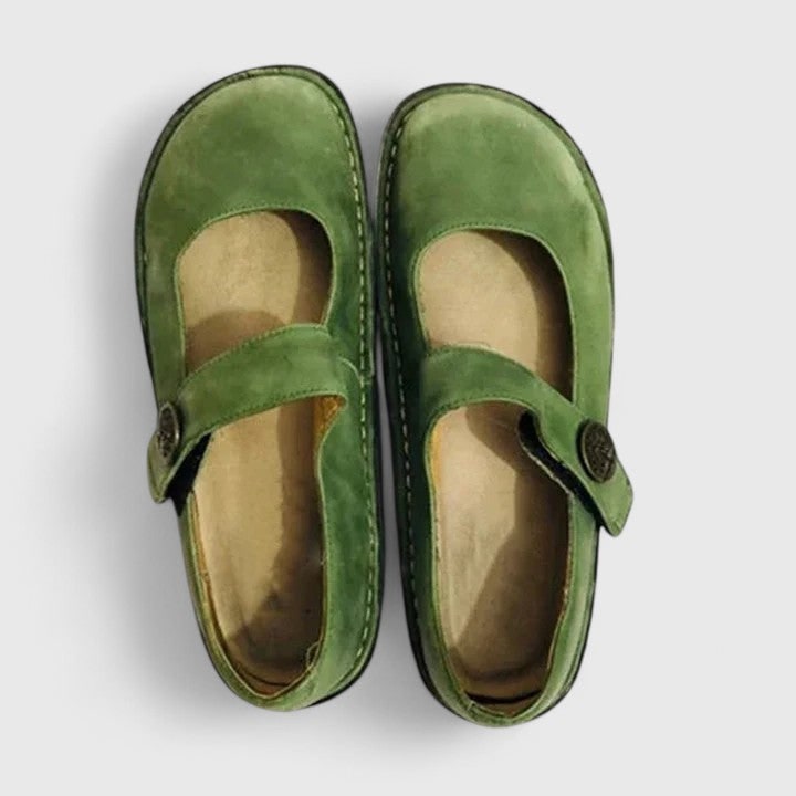 Classic women's Mary Jane flats with round toe, adjustable strap & cushioned comfort for versatile casual or office wear.