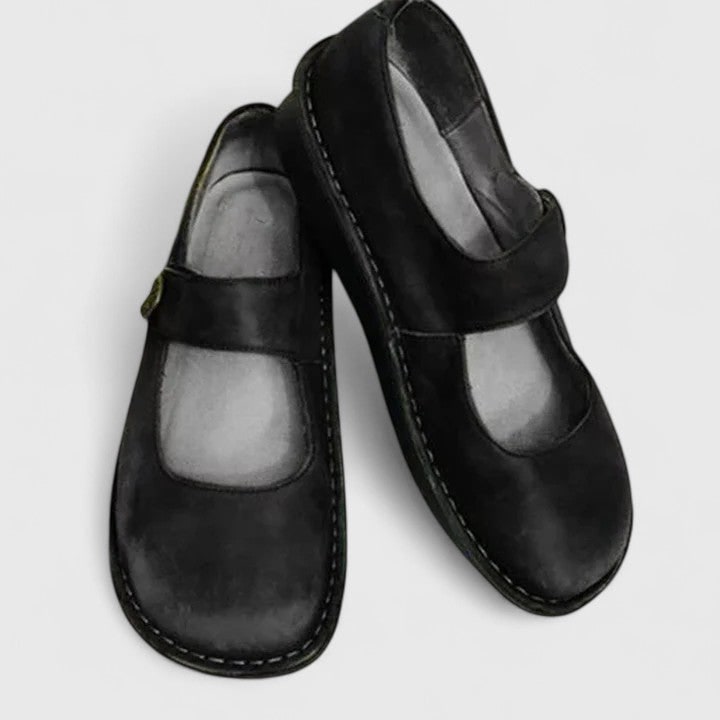 Slip-on Mary Jane flats for women. Cushioned insole, adjustable strap & round toe for ultimate comfort & style.
