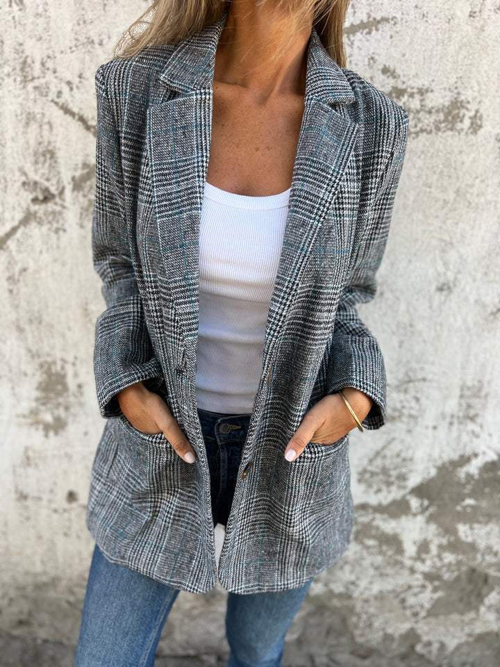 Front view of a classic houndstooth oversized blazer for women. Chic notched lapel design, perfect for workwear fashion.