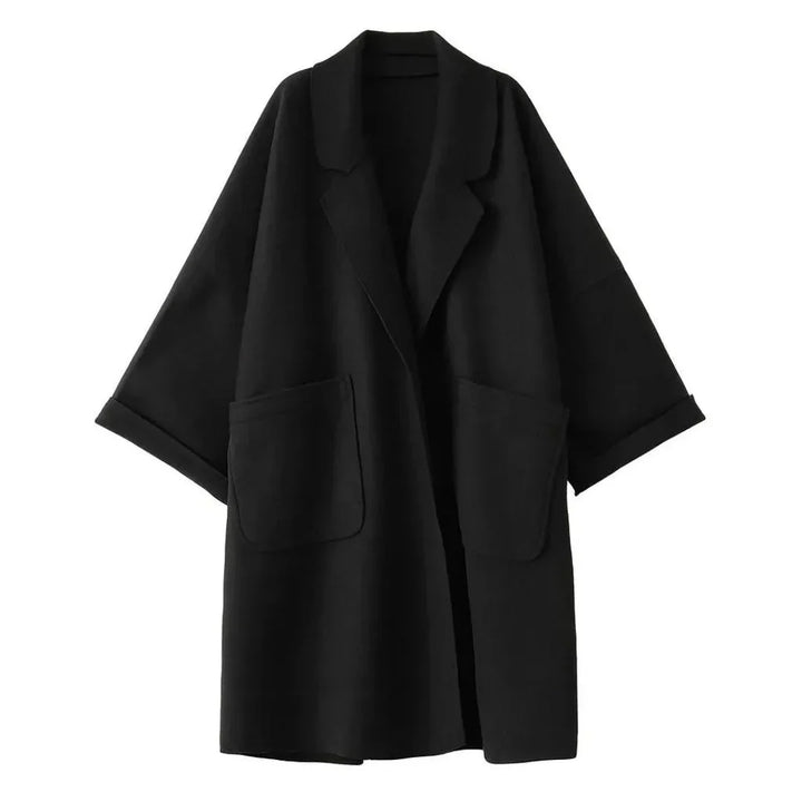 Stylish women's black trench coat, oversized with elegant lapel detail & practical pockets for chic outerwear.