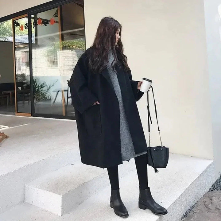 Cozy women's oversized trench coat in coffee with generous pockets, a versatile long jacket for fall/winter.