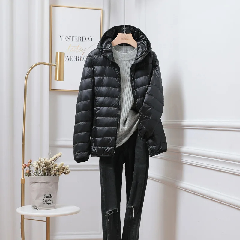 Quilted women's hooded puffer jacket, a warm winter outerwear choice. Great for casual cold weather & travel.