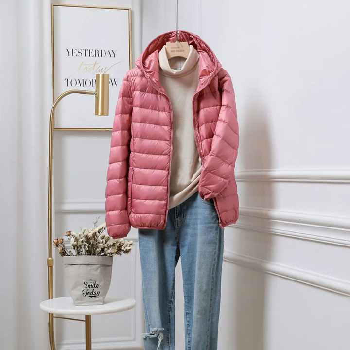 Women's hooded puffer jacket, ideal for warm winter outerwear & cold weather. Quilted design, casual style.