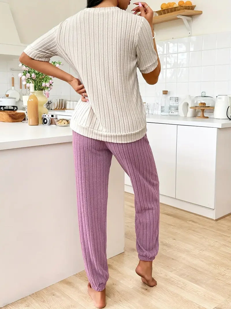 Ladies' purple heart print pyjama set. Comfortable two-piece nightwear, perfect for cozy evenings.