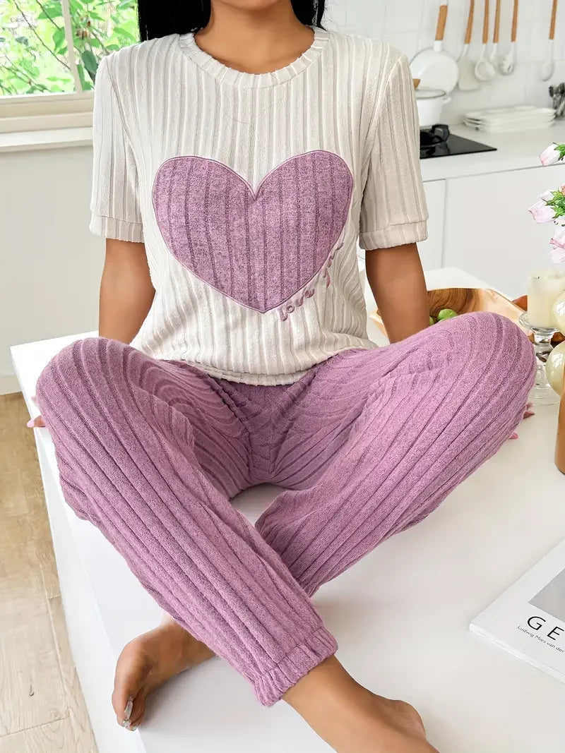 Women's cozy heart print pyjama set. Soft two-piece loungewear for comfortable sleep & relaxation.