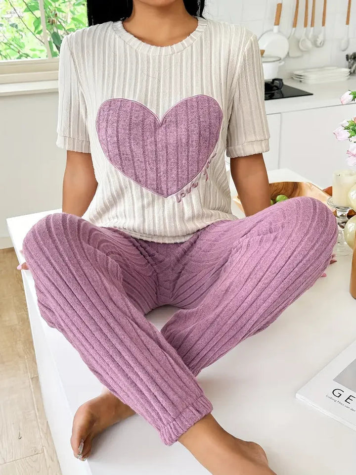 Women's cozy heart print pyjama set. Soft two-piece loungewear for comfortable sleep & relaxation.