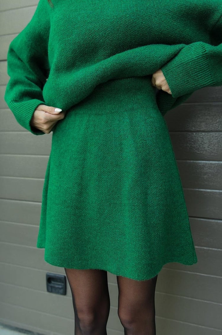Modern women's oversized knit sweater & mini skirt set. Fashionable two-piece co-ord.