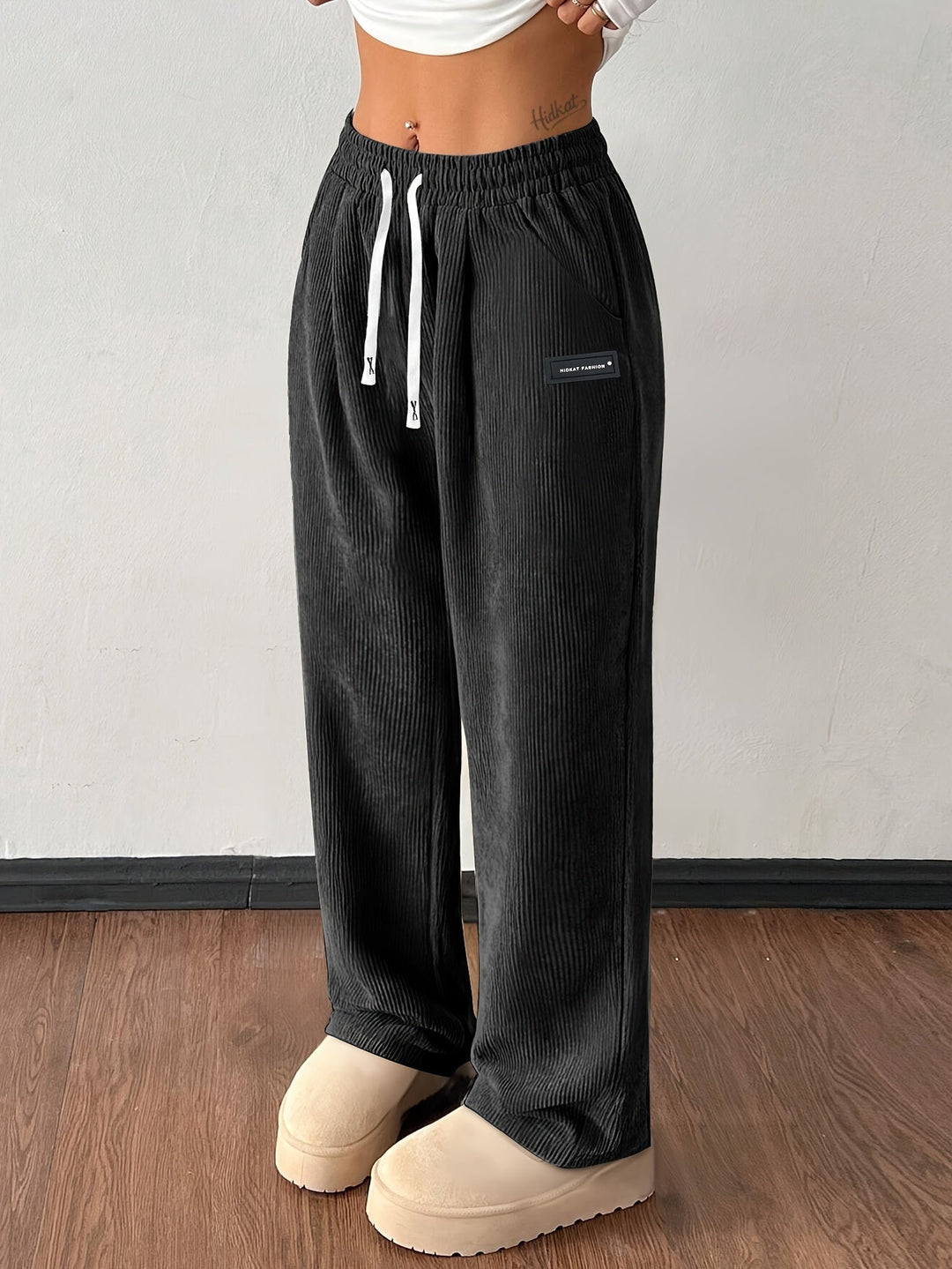 Casual women's textured wide leg corduroy pants, a fashionable and baggy streetwear staple.