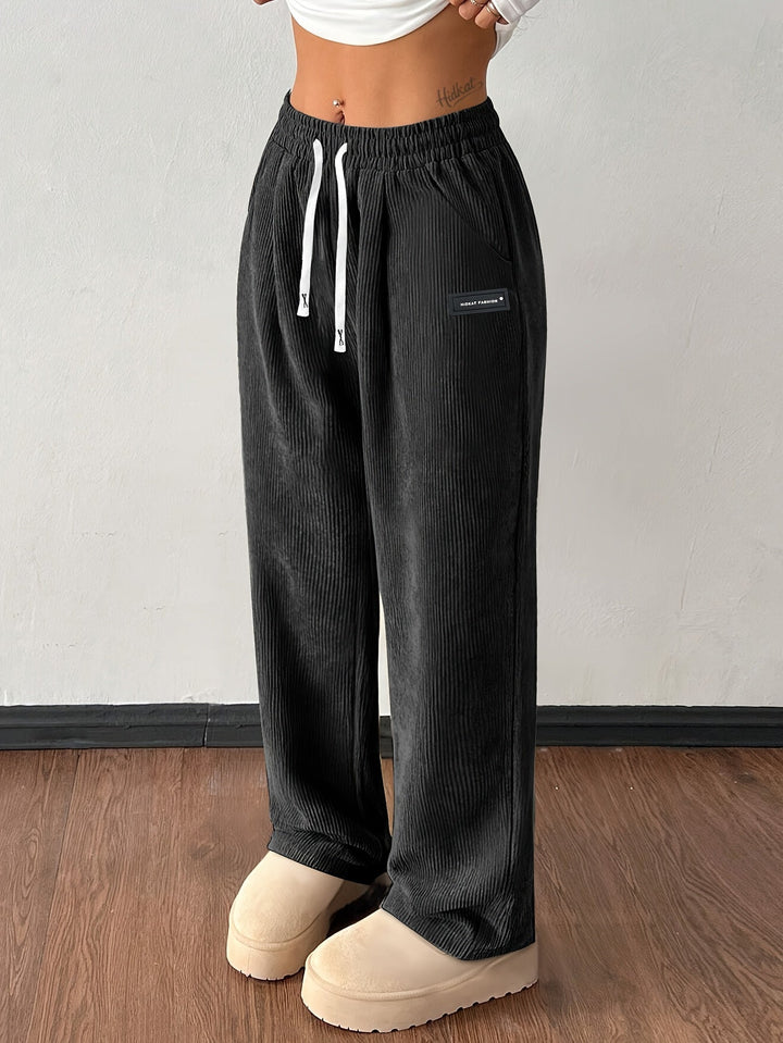 Casual women's textured wide leg corduroy pants, a fashionable and baggy streetwear staple.