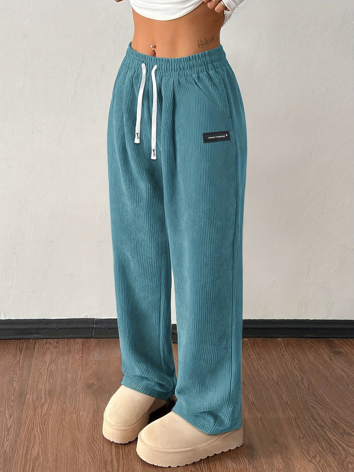 Women's baggy wide leg corduroy pants with pockets and drawstring waist, perfect for casual wear.