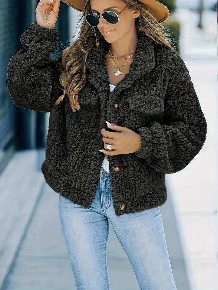Stylish women's warm button-up winter jacket with a cozy collar, perfect for cold weather fashion.