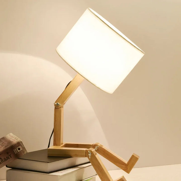 Compact wooden table lamp with clever book holder. RutanFlex adjustable design, perfect for small spaces & reading.