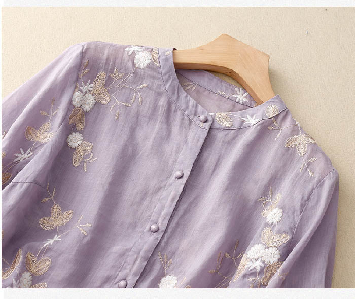 Women's elegant spring blouse: sheer, layered, and adorned with delicate floral embroidery.